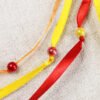 Close Up of Flaming Phoenix Myrrh Leaf Pouch with red, orange and yellow ribbons and iridescent red and yellow plastic beads