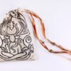 Closed cream handprinted fabric mythology drawstring bag with Cernunnos oak leaf print with ribbons and beads splayed out