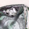 Green Poly-Satin Moon Gate pouch with dark grey poly-satin lining, white rune stones that spell Imogen are inside the pouch