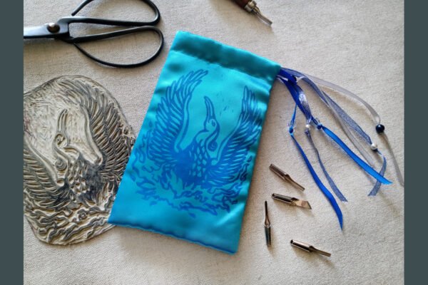Hand printed pouch with, lino cutters, forged scissors and hand carved lino stamp which was used for printing this pouch